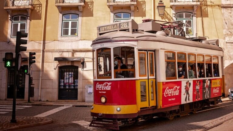 Lisbon on a Budget - Tram on City Street in Lisbon